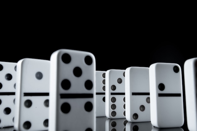 White dominoes in the dark close up