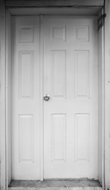 A white door with a silver knob on it and a door with a silver knob.