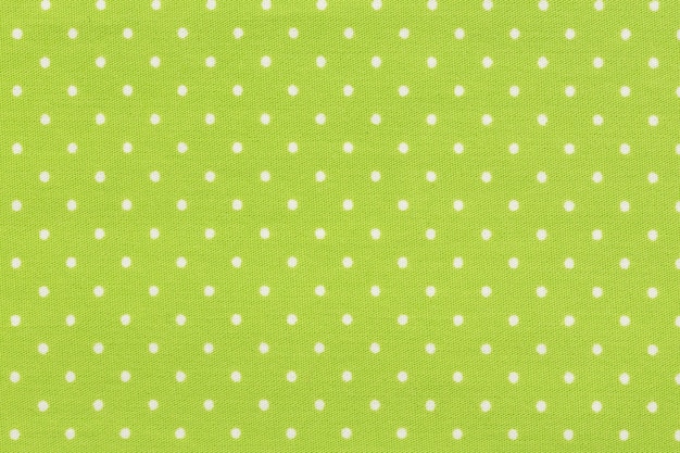 White dot over yellow polka dot fabric background and texture