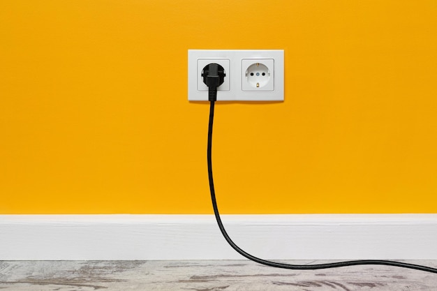 White double outlet on yellow wall