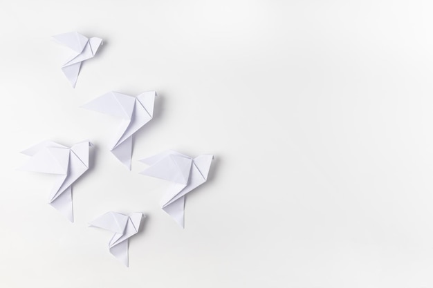 White dove origami as a symbol of peace on a white background