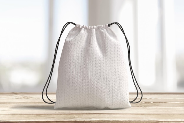 White Drawstring Bag on Wooden Table