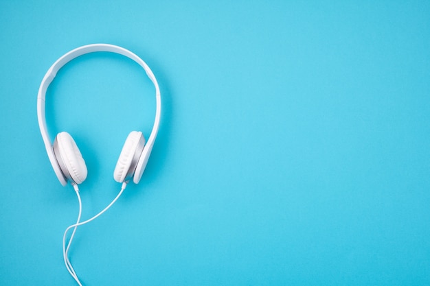 White earphones on blue background