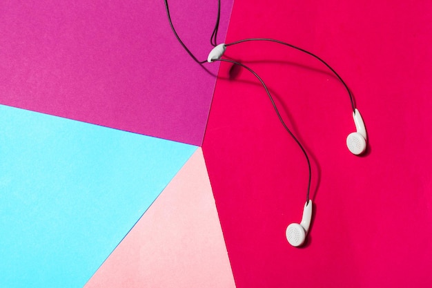 White earphones on colorful background