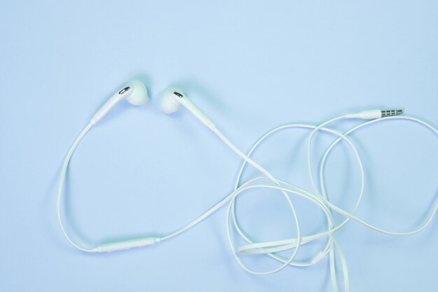 White Earphones or ear buds small talk on sweet blue