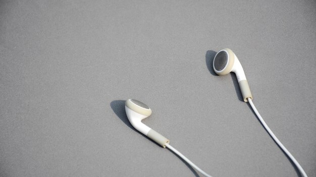 White earphones on grey background