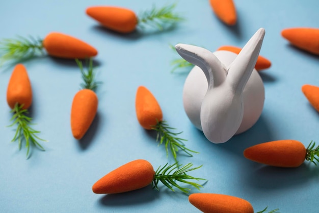 White easter bunny with orange carrots Easter composition