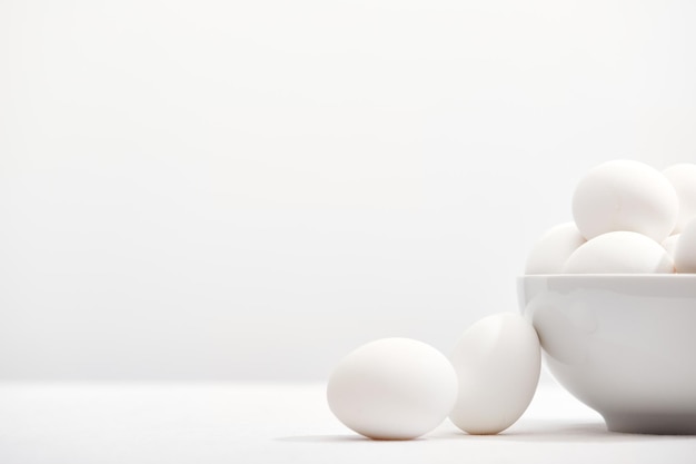 White eggs bowl on table with copyspace