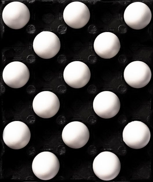 White Eggs Pattern on Dark Background Top Down View