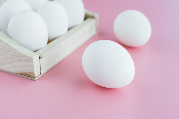 White eggs on pink background for food cooking