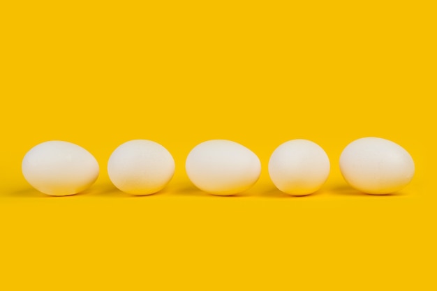 White eggs on a yellow background