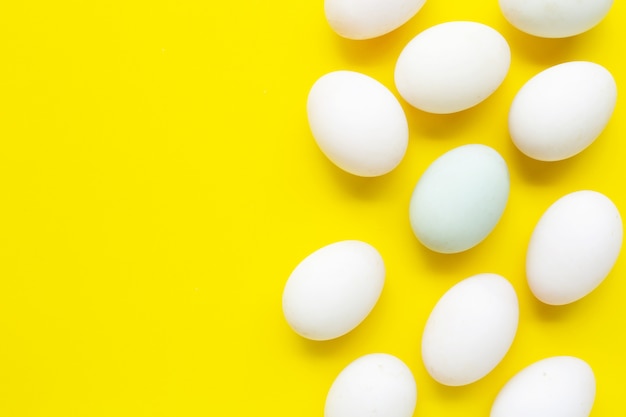 White eggs on yellow background. 