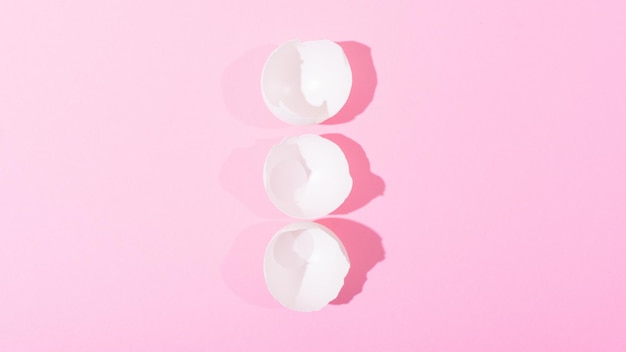 White eggshell on a pink background view from above