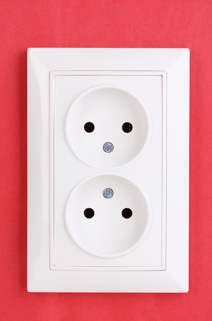 Photo white electric socket on the wall