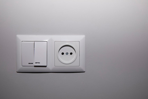 white electrical plugs in the home wall