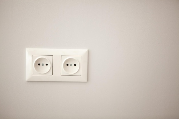 White electrical socket mounted on the wall