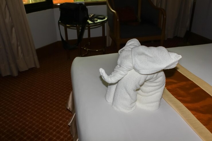 Photo white elephant on bed in house