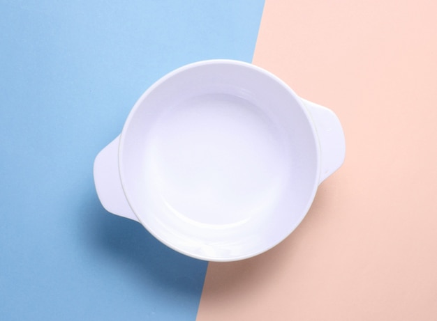 White empty bowl on pastel color isolated