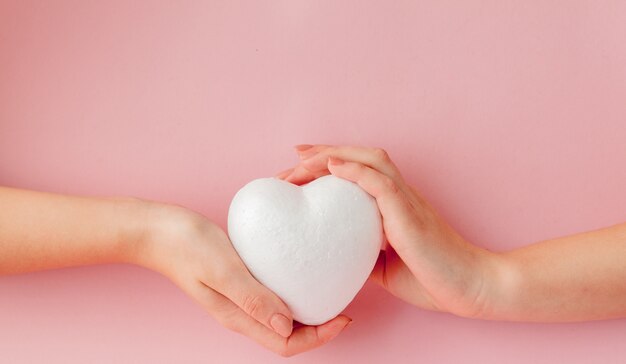 White empty love heart in hands