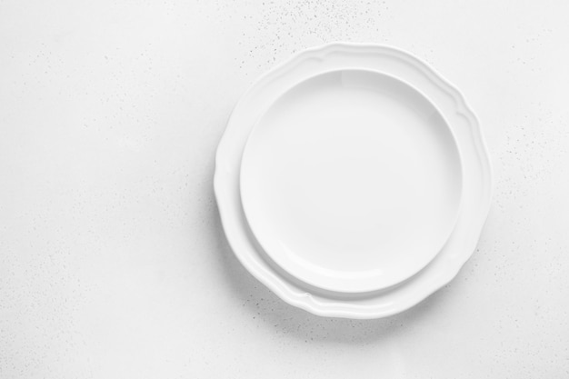 White empty plates on white background