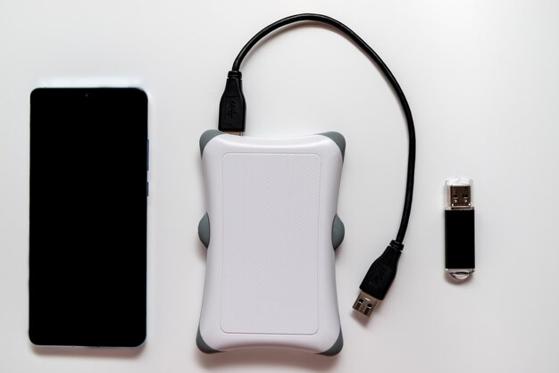 White external disk, usb flash and smartphone