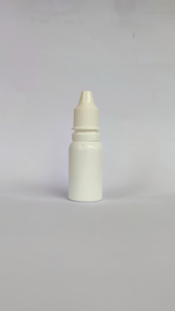 Photo white eye drop bottle in white background