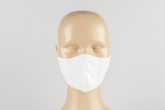 White fabric face mask on a mannequin