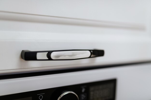 White facades on kitchen furniture metal handles