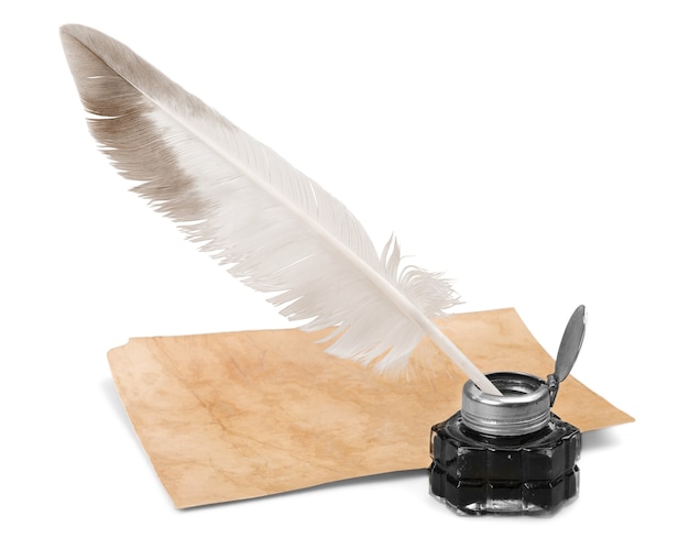 White feather quill pen, glass inkwell and old letter isolated on a white background