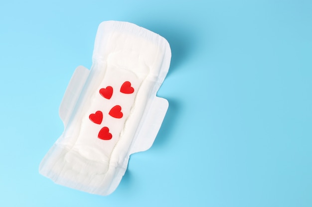 White feminine pads with red hearts