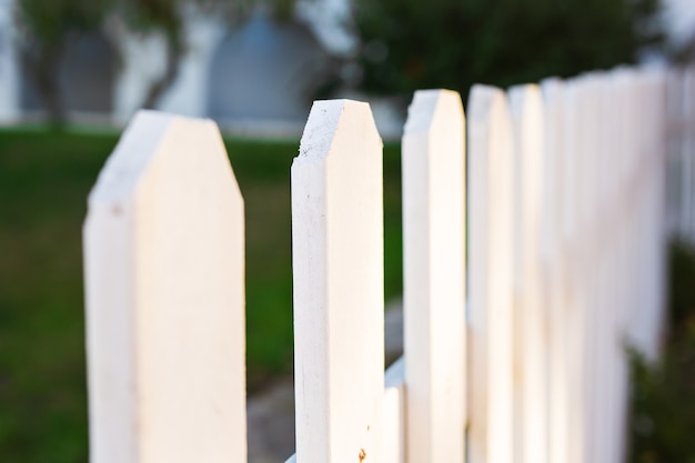 White fence close up and green grass