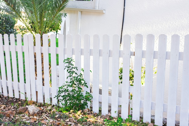 White fence in perspective and green grass