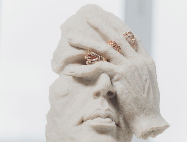 White figurines with wedding rings on closeup