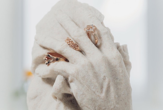 White figurines with wedding rings on closeup