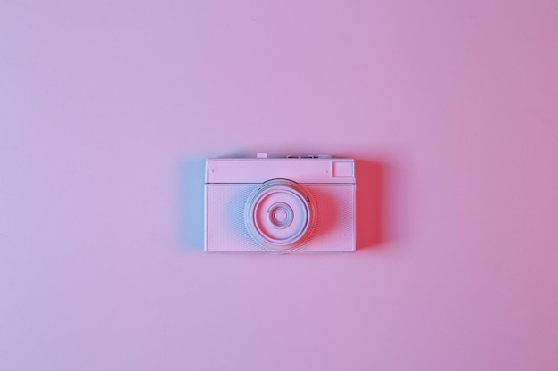 Photo white film camera in pinkblue neon gradient light minimalism creative layout