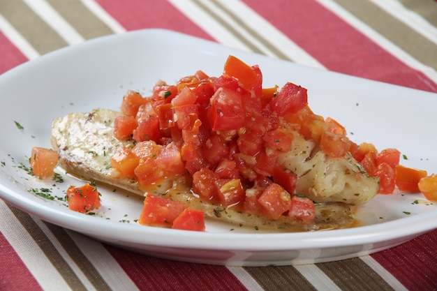 White fish fillets in rich tomato sauce.