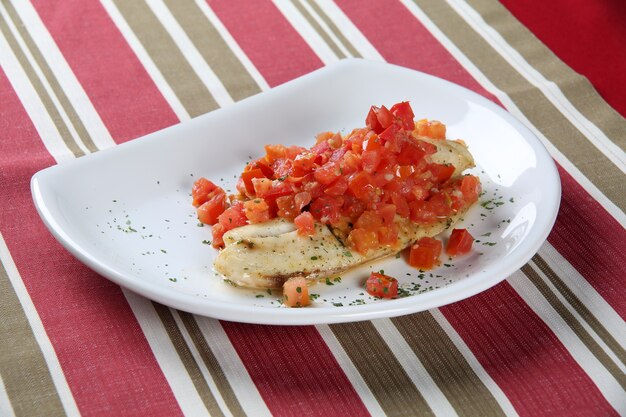 White fish fillets in rich tomato sauce.