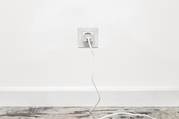 White fiveway wall power socket installed on the white wall front view