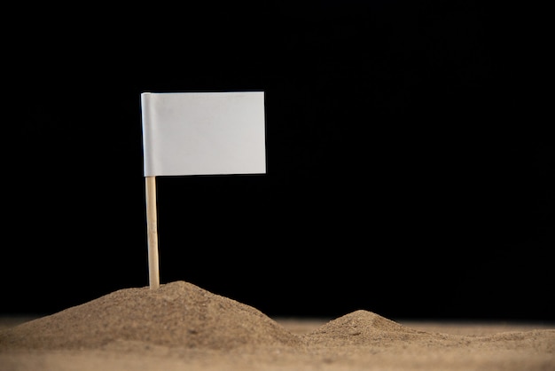 White flag on moon on dark surface