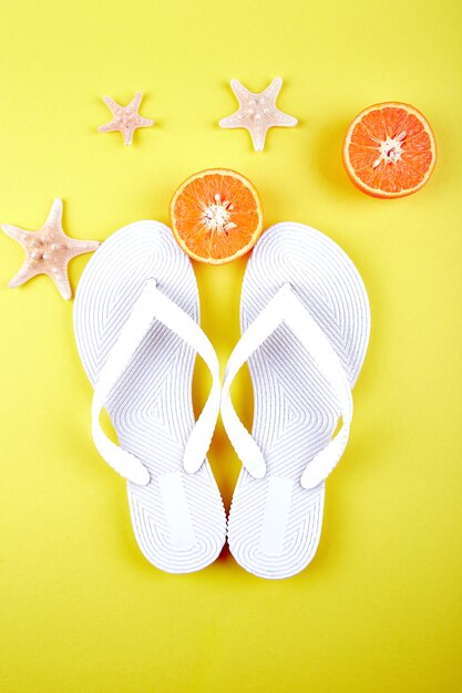 White Flip flops, Orange fruit, starfish