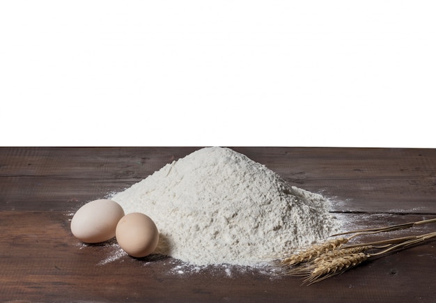 white flour and eggs isolated on white background