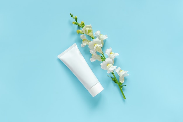 Photo white flower and cosmetic, medical white tube for cream, ointment, toothpaste. natural organic cosmetics
