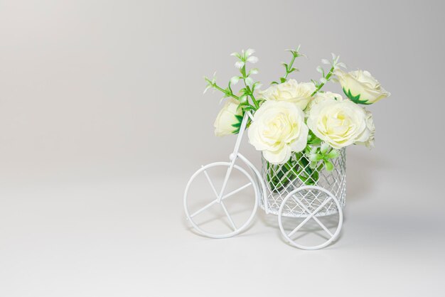 White flowers in a bicycle basket on a white background