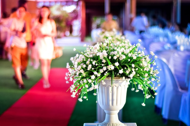 Photo white flowers in pedestal urn