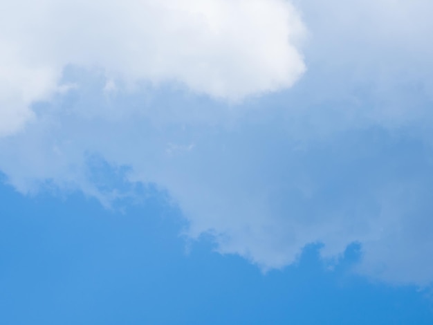 White fluffy clouds in blue sky for background