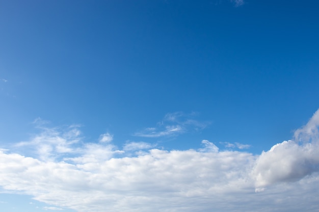 Белые пушистые облака на ярко-голубом небе в летний день