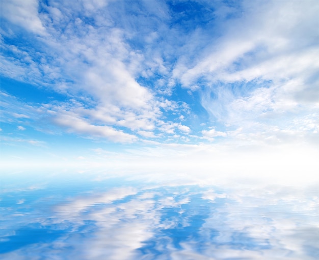 White fluffy clouds with rainbow in the blue sky