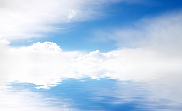 White fluffy clouds with rainbow in the blue sky