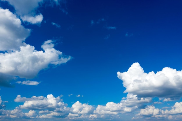 White fluffy clouds with rainbow in the blue sky