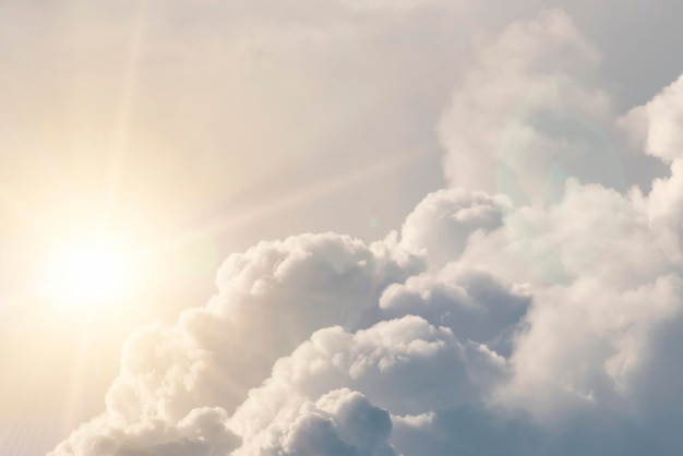 White fluffy clouds with the sun background